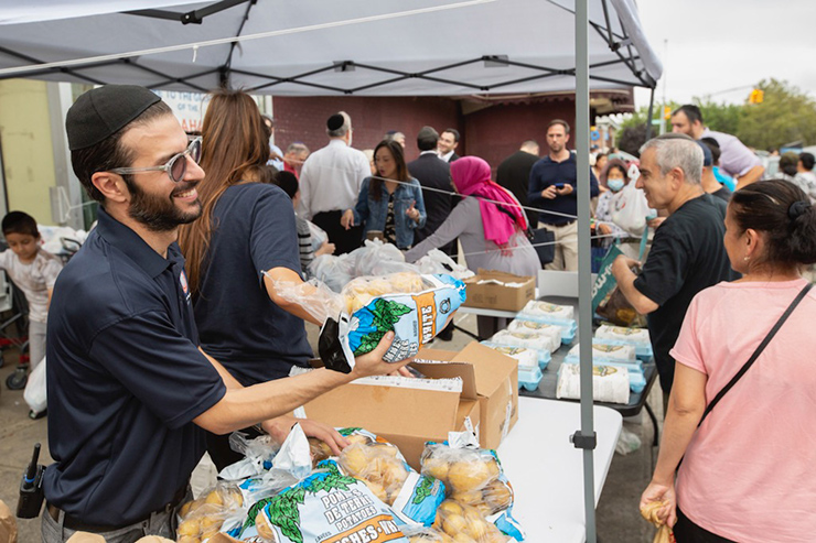 Simon Sebag seen distributing Idaho potatos, an essential cooking ingredient to needy in the community.